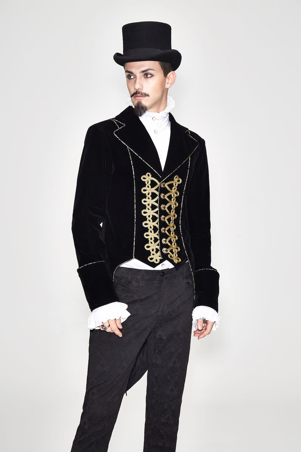 CT099 Bad Boy Baroque tailcoat jacket by Devil Fashion. Gold braid detail, black velvet, sharp tailoring, shown on gothic model