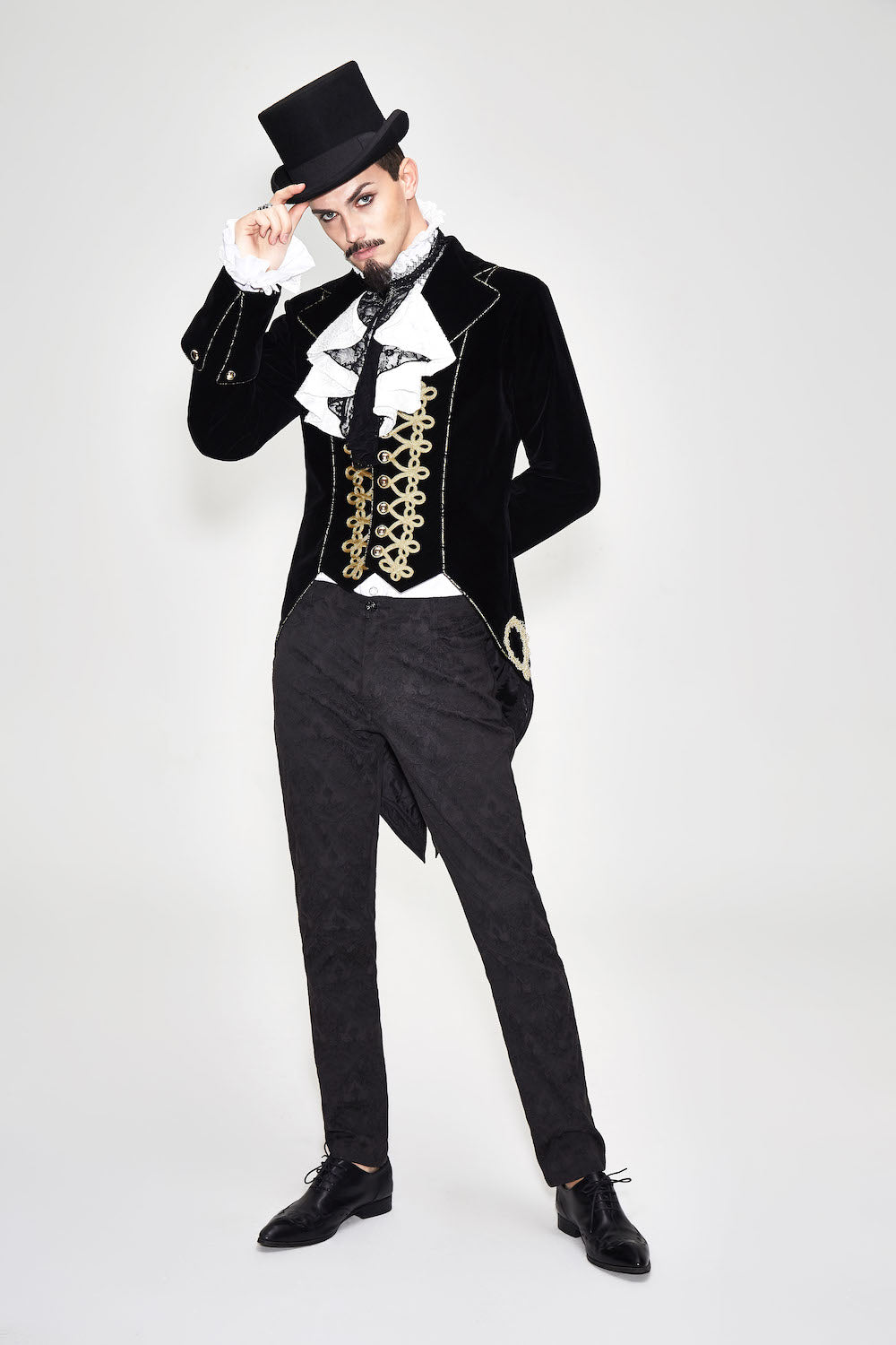 CT099 Bad Boy Baroque tailcoat jacket by Devil Fashion. Gold braid detail, black velvet, sharp tailoring, worn by a gothic groom